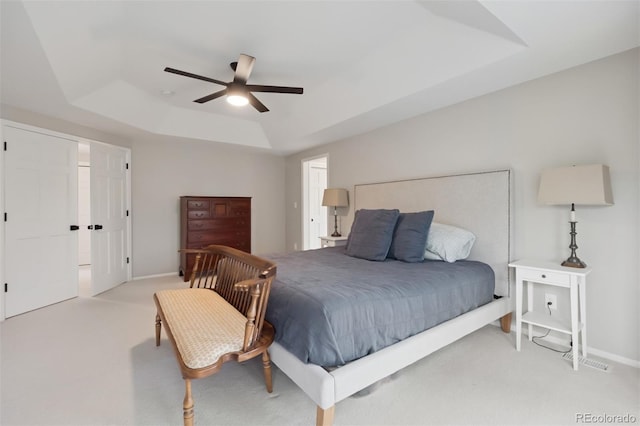 3566 E Meadow Creek Pl, Highlands Ranch, CO 80126 - bedroom with a tray ceiling, light carpet, a ceiling fan, and baseboards