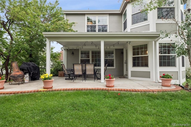 3566 E Meadow Creek Pl, Highlands Ranch, CO 80126 - rear view of house featuring a patio area and a lawn