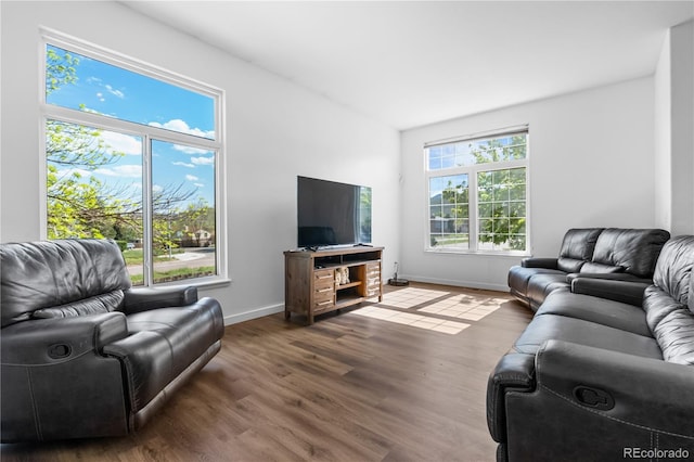 living area featuring dark wood finished floors and baseboards