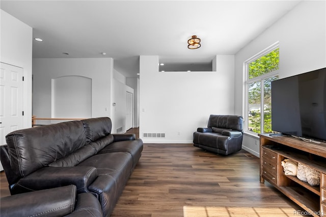 living area with wood finished floors, baseboards, and recessed lighting