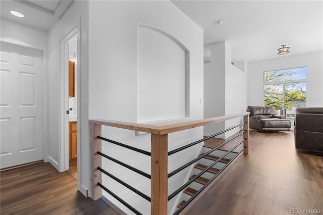 corridor featuring wood finished floors, an upstairs landing, baseboards, and recessed lighting