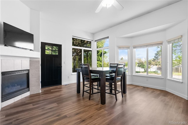 dining area with healthy amount of natural light, baseboards, and dark wood finished floors