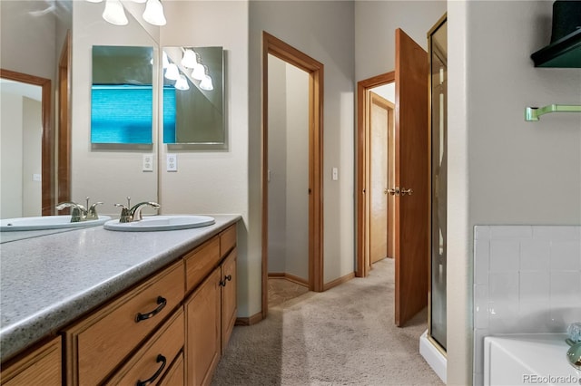 full bath with a bath, vanity, and baseboards