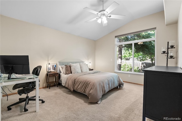bedroom featuring vaulted ceiling, light carpet, a desk, baseboards, and ceiling fan