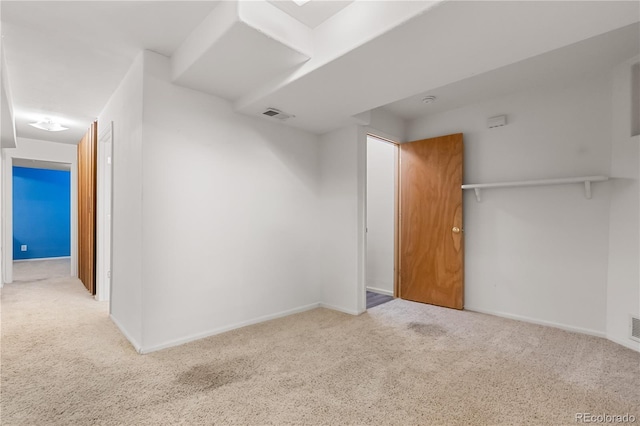 unfurnished bedroom featuring carpet and baseboards