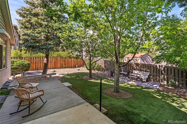 view of yard with a wooden deck and outdoor lounge area