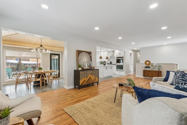 living room with baseboards, light wood-style flooring, and recessed lighting