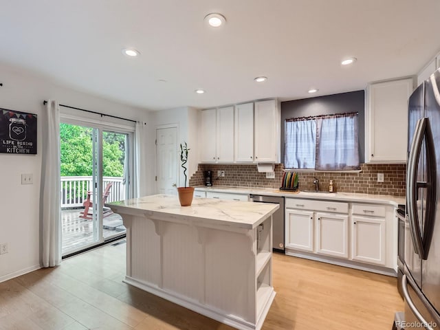 426 N 48th Ave, Brighton, CO 80601 - kitchen with dishwasher, freestanding refrigerator, white cabinetry, decorative backsplash, and recessed lighting