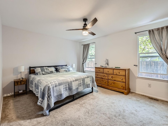 426 N 48th Ave, Brighton, CO 80601 - carpeted bedroom with multiple windows and ceiling fan