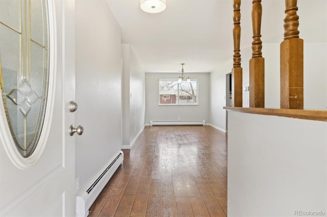 foyer featuring baseboards, dark wood-style flooring, baseboard heating, and a baseboard radiator