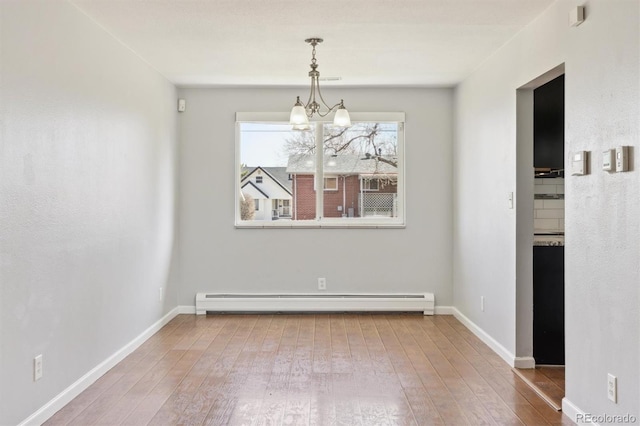 unfurnished dining area featuring hardwood / wood-style floors, an inviting chandelier, baseboards, and baseboard heating