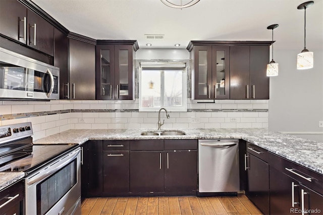 kitchen with light wood-type flooring, visible vents, appliances with stainless steel finishes, and a sink