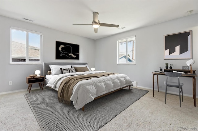 carpeted bedroom with baseboards, visible vents, and ceiling fan