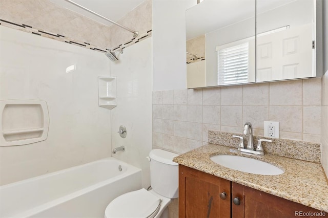 bathroom featuring vanity, toilet, tile walls, and shower / bathtub combination