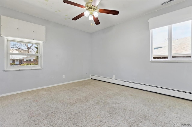 carpeted spare room featuring visible vents, ceiling fan, baseboards, and a baseboard radiator