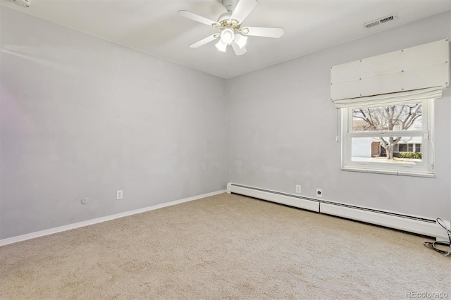 carpeted spare room featuring a ceiling fan, visible vents, baseboard heating, and baseboards