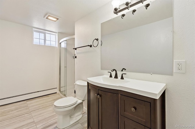 bathroom featuring baseboard heating, a shower stall, toilet, and vanity