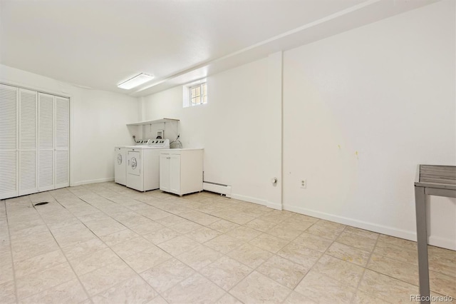 washroom featuring a baseboard heating unit, baseboards, separate washer and dryer, and laundry area