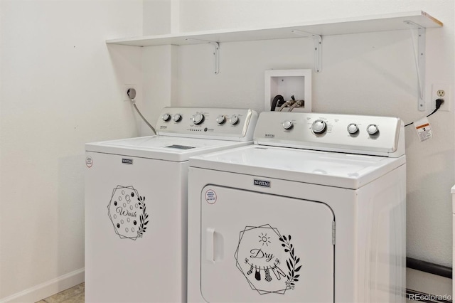 clothes washing area featuring laundry area, washing machine and dryer, and baseboards