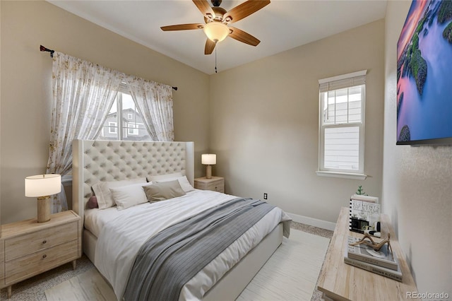 bedroom with a ceiling fan and baseboards