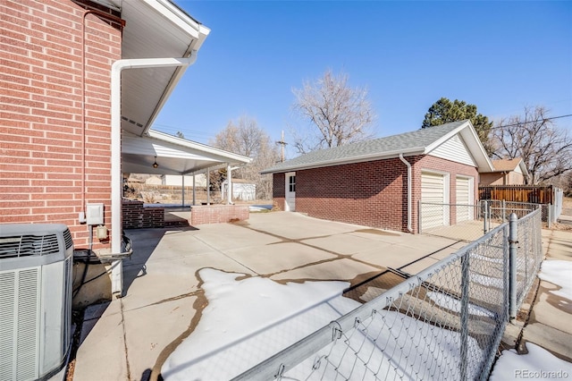 view of home's exterior with cooling unit, a garage, and an outdoor structure