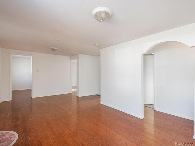 empty room with dark hardwood / wood-style floors