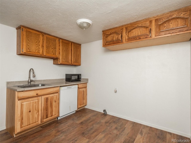 kitchen with sink, white dishwasher, dark wood-type flooring, and a textured ceiling