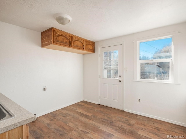 interior space featuring hardwood / wood-style flooring and a textured ceiling