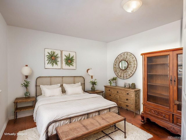 bedroom with dark wood-type flooring