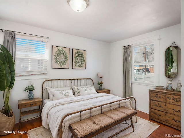 bedroom with dark hardwood / wood-style flooring