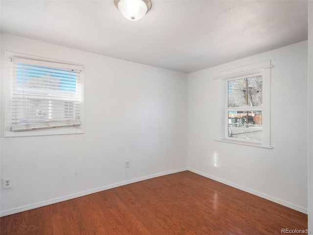 empty room featuring a healthy amount of sunlight and wood-type flooring