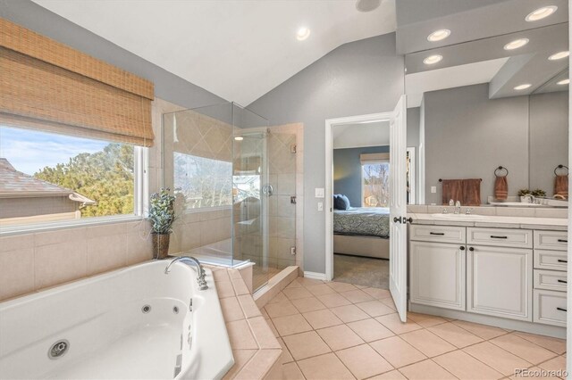 full bath featuring vanity, lofted ceiling, a jetted tub, a shower stall, and ensuite bath