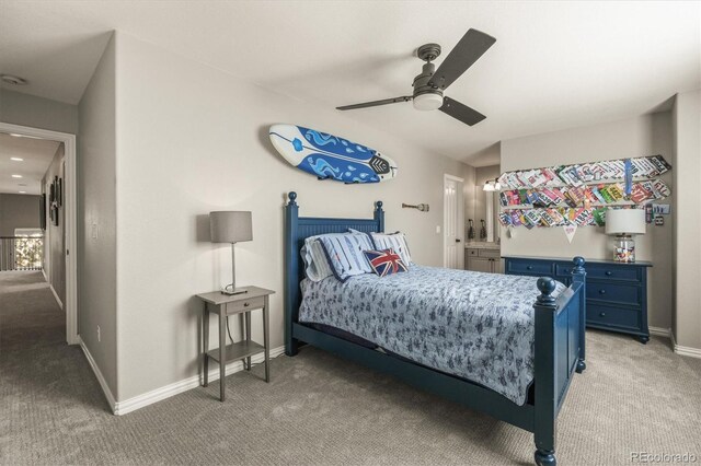 bedroom with a ceiling fan, baseboards, and light colored carpet