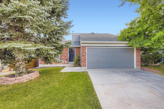 12476 W Prentice Pl, Littleton, CO 80127 - view of front of house with brick siding, driveway, an attached garage, and a front yard