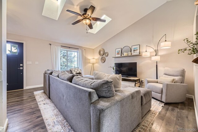 12476 W Prentice Pl, Littleton, CO 80127 - living room featuring a skylight, ceiling fan, lofted ceiling, and dark wood-style floors