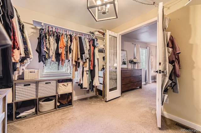 12476 W Prentice Pl, Littleton, CO 80127 - spacious closet with carpet flooring and a chandelier