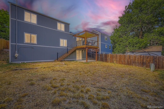 12476 W Prentice Pl, Littleton, CO 80127 - back of property at dusk with stairs and a deck