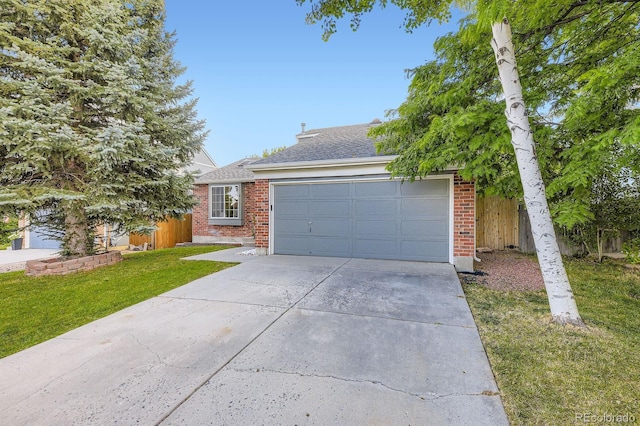 12476 W Prentice Pl, Littleton, CO 80127 - obstructed view of property with driveway, an attached garage, brick siding, and roof with shingles