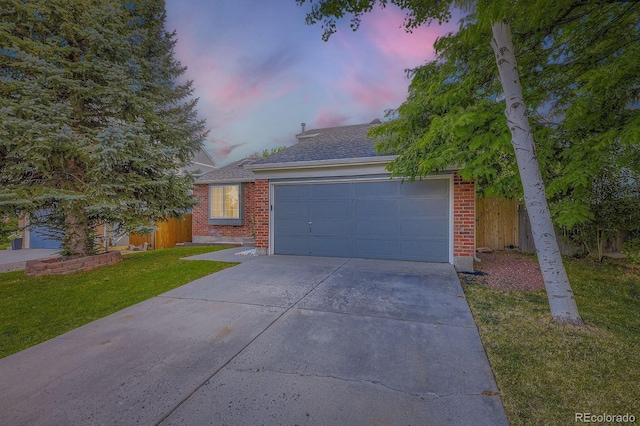 12476 W Prentice Pl, Littleton, CO 80127 - view of front of property with concrete driveway, a garage, brick siding, and roof with shingles