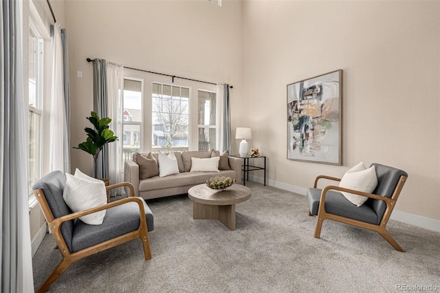 16434 Homestead Ct, Parker, CO 80134 - carpeted living area featuring a towering ceiling, baseboards, and a wealth of natural light
