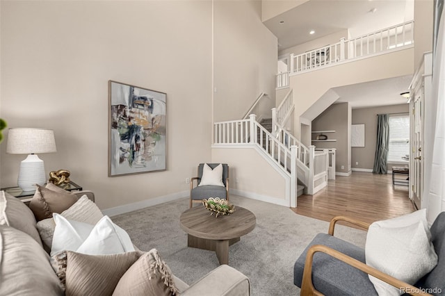 16434 Homestead Ct, Parker, CO 80134 - carpeted living area featuring a high ceiling, stairs, and baseboards