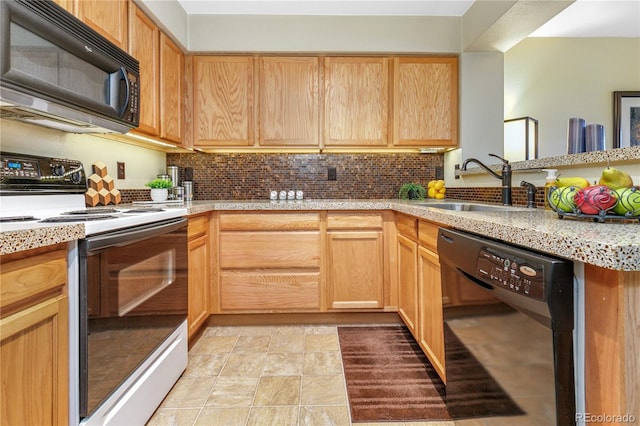 kitchen with black appliances, a peninsula, tasteful backsplash, and a sink