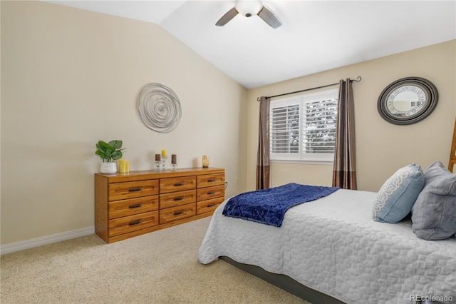 carpeted bedroom with ceiling fan, baseboards, and lofted ceiling