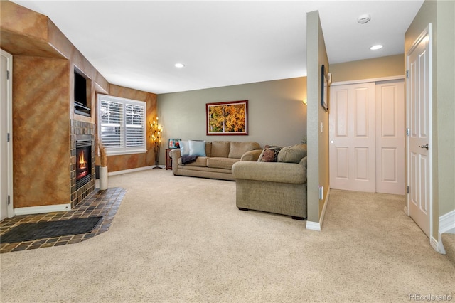 carpeted living room with recessed lighting, a tile fireplace, and baseboards