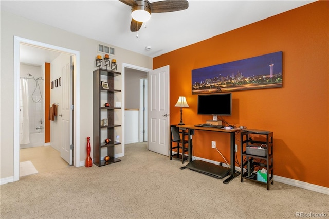 carpeted office space featuring visible vents, baseboards, and ceiling fan