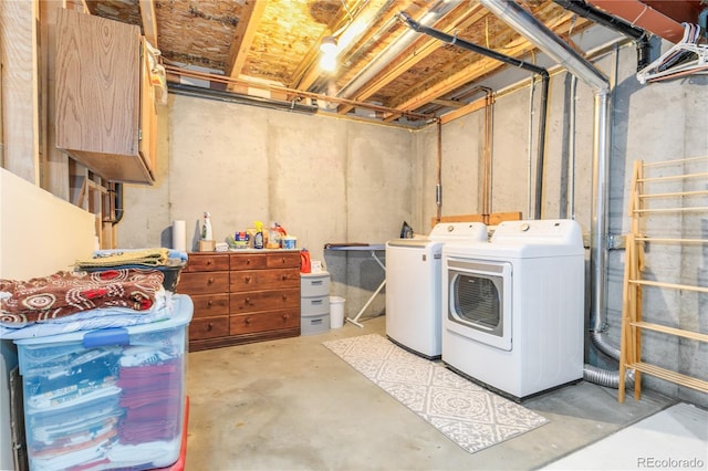 unfinished basement featuring washing machine and clothes dryer