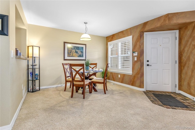 carpeted dining room with baseboards