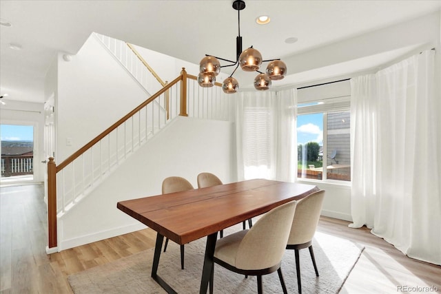 11575 Wilson Cir, Parker, CO 80134 - dining area with stairway, light wood-style flooring, a chandelier, and recessed lighting