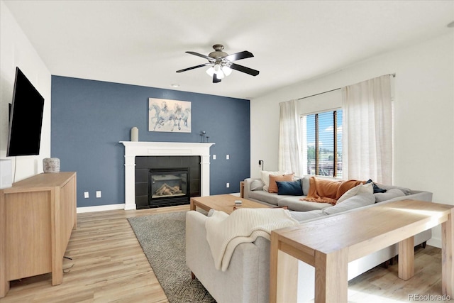 11575 Wilson Cir, Parker, CO 80134 - living room featuring ceiling fan, light wood-style flooring, and a tiled fireplace