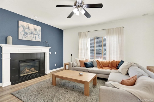 11575 Wilson Cir, Parker, CO 80134 - living area with wood finished floors, a tile fireplace, and a ceiling fan